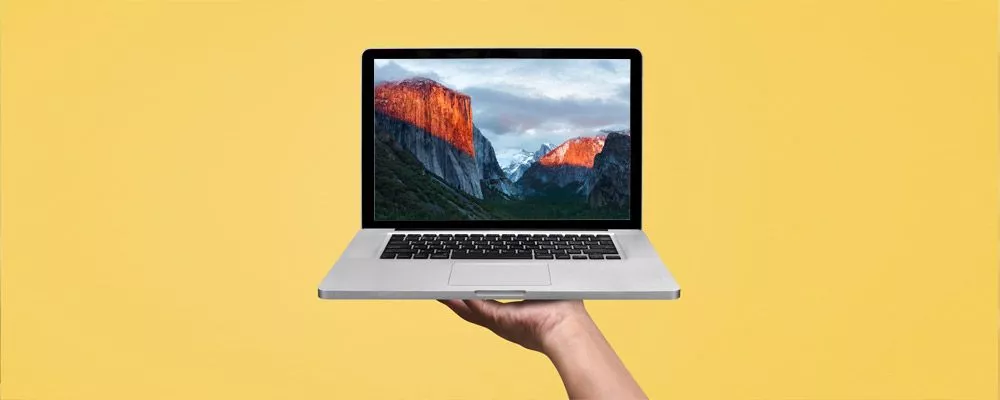A Macbook on a yellow background
