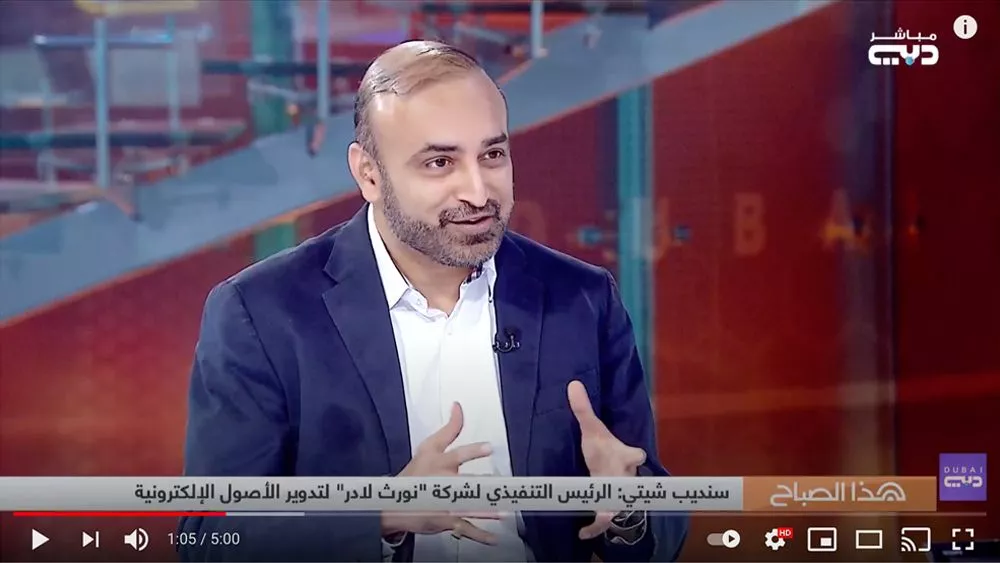 NorthLadder CEO Sandeep Shetty on DubaiTV, speaking passionately about the company's mission with a Dubai cityscape in the background.